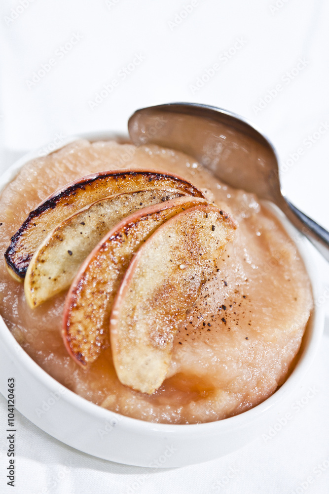 caramelized apple slices on bowl of apple sauce caramelized apple slices on bowl of apple sauce