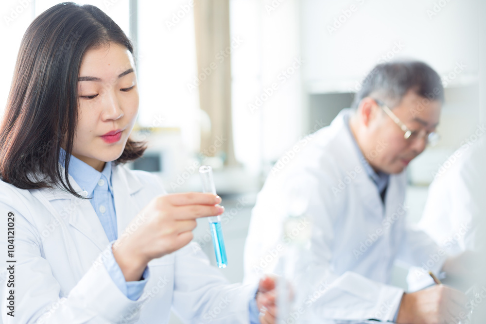 people doing chemical experiment in modern lab people doing chemical experiment in modern lab