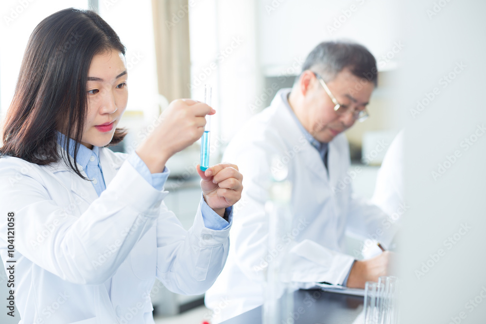 people doing chemical experiment in modern lab people doing chemical experiment in modern lab