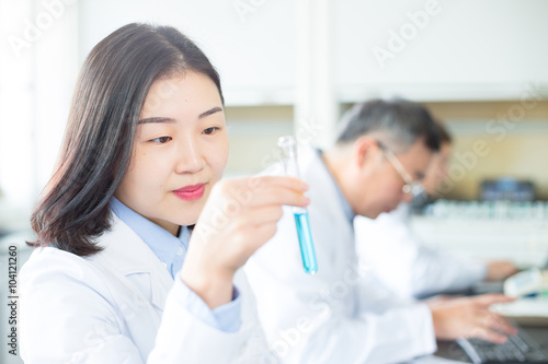 people doing chemical experiment in modern lab