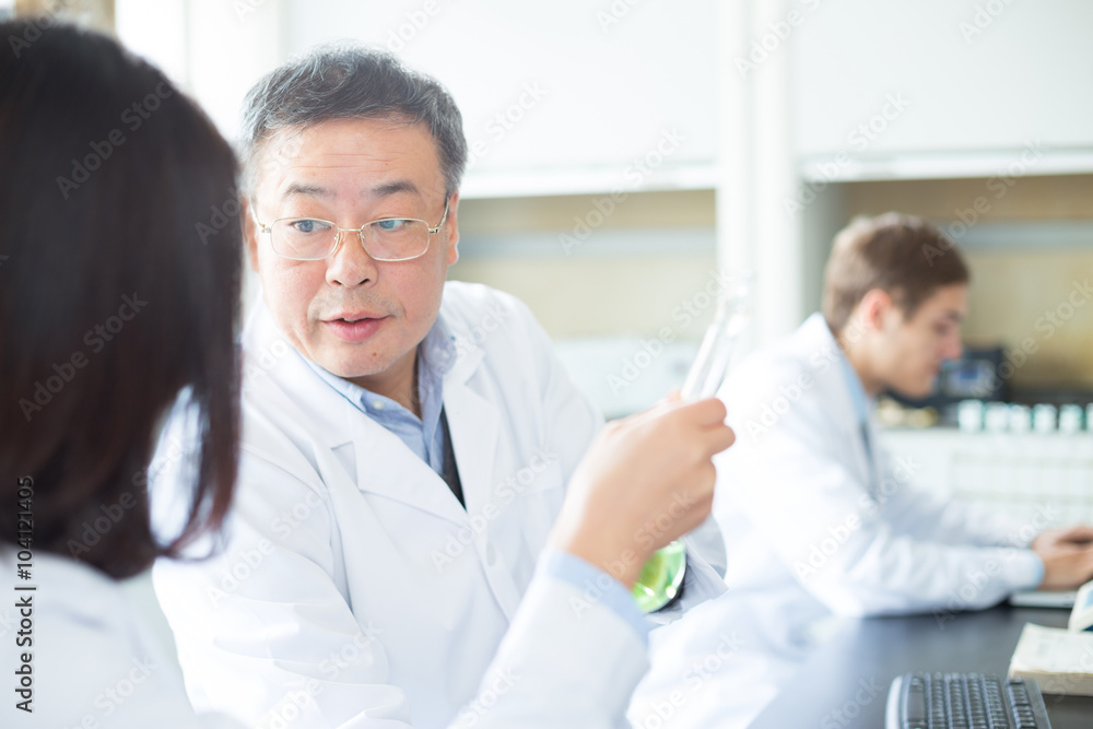 people doing chemical experiment in modern lab people doing chemical experiment in modern lab