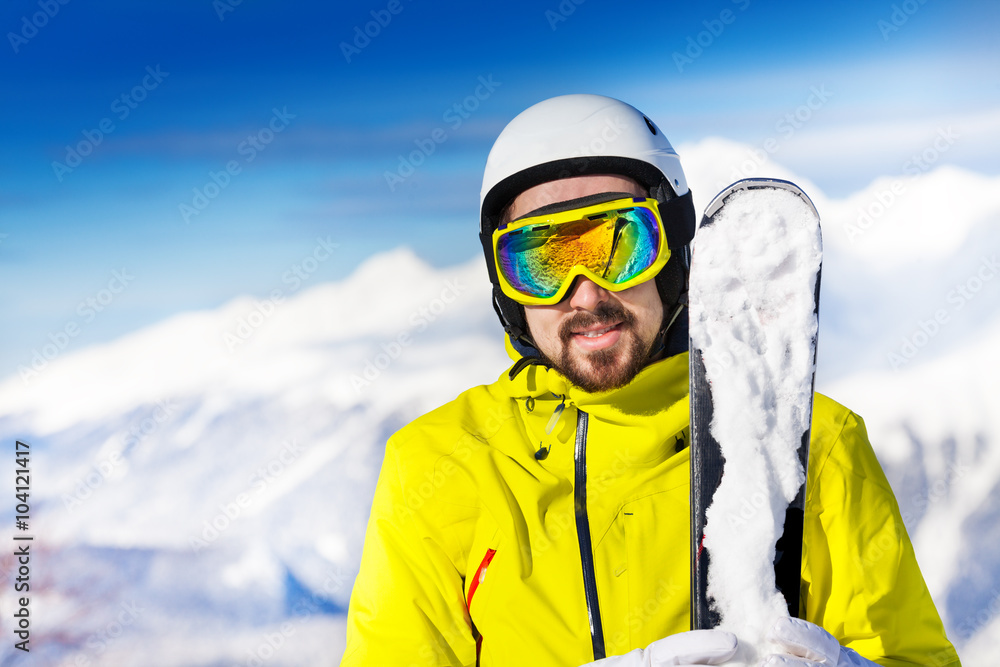 Portrait of man with ski over mountains Portrait of man with ski over mountains