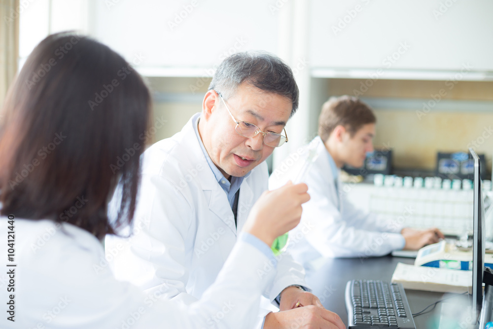 people doing chemical experiment in modern lab people doing chemical experiment in modern lab