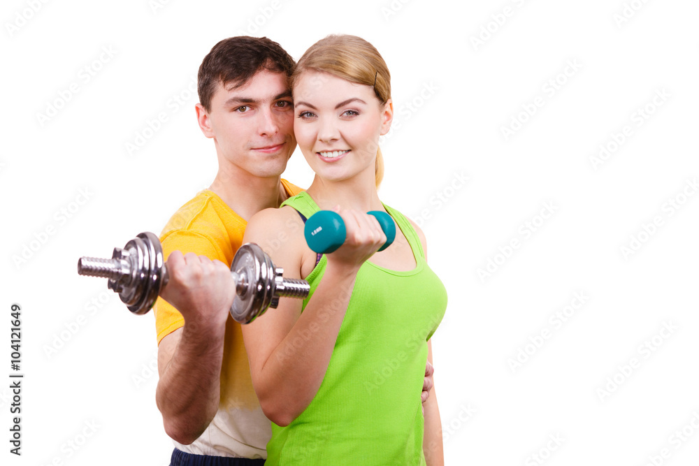 Couple exercising with dumbbells lifting weights Couple exercising with dumbbells lifting weights