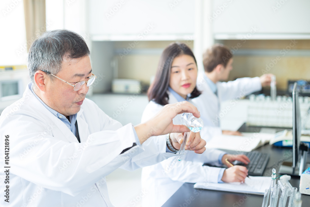 people doing chemical experiment in modern lab people doing chemical experiment in modern lab