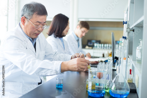 people doing chemical experiment in modern lab