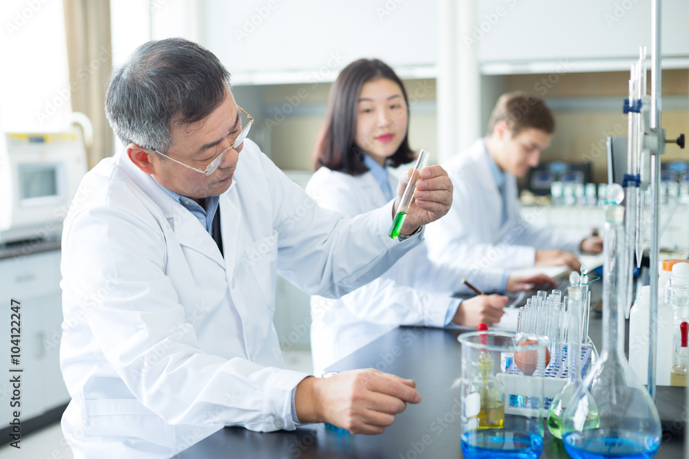 people doing chemical experiment in modern lab