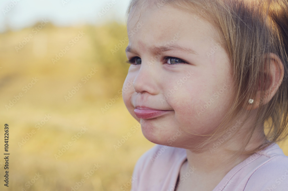 Fototapeta premium The little girl was crying, offended, upset and distressed.