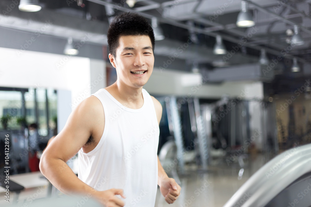 young handsome man working out in modern gym