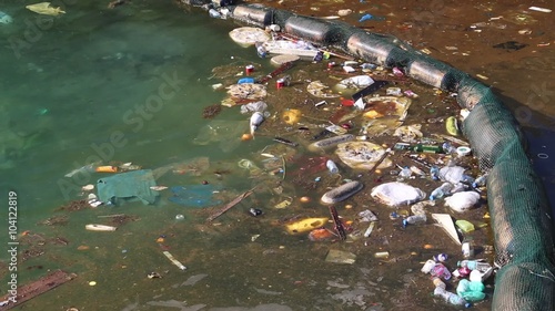 Garbage floats in the sea near the coast. Muddy water. Abuse of environment photo