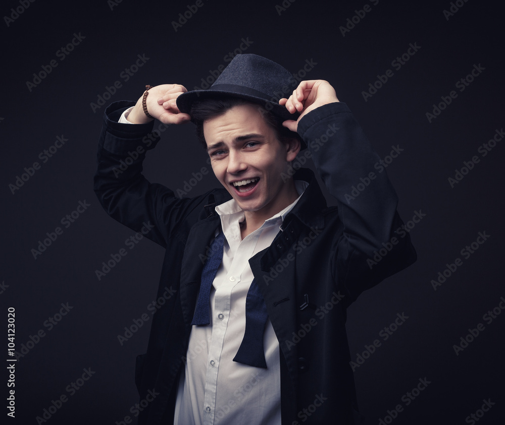 Vogue handsome man in the hat and untied tie bow in the studio portrait Vogue handsome man in the hat and untied tie bow in the studio portrait