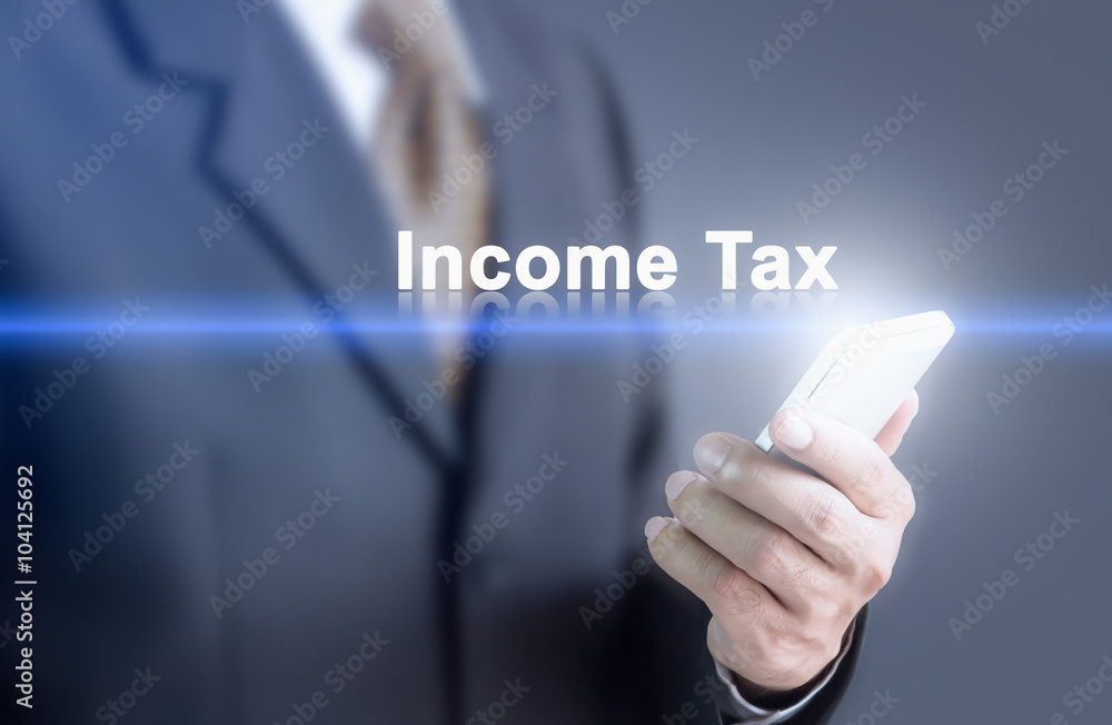 Businessman pressing hand Income Tax word on virtual screen. Can bring to the medium of your ad. Businessman pressing hand Income Tax word on virtual screen. Can bring to the medium of your ad.
