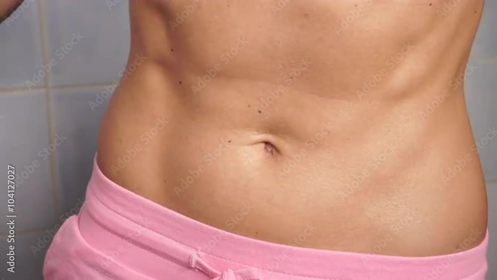 Woman showing some strong abs and flat belly close up 4K Woman showing some strong abs and flat belly close up 4K