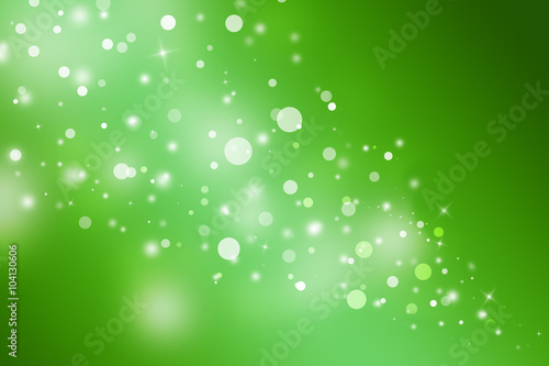 Green glitter sparkles defocused rays lights bokeh abstract christmas background.