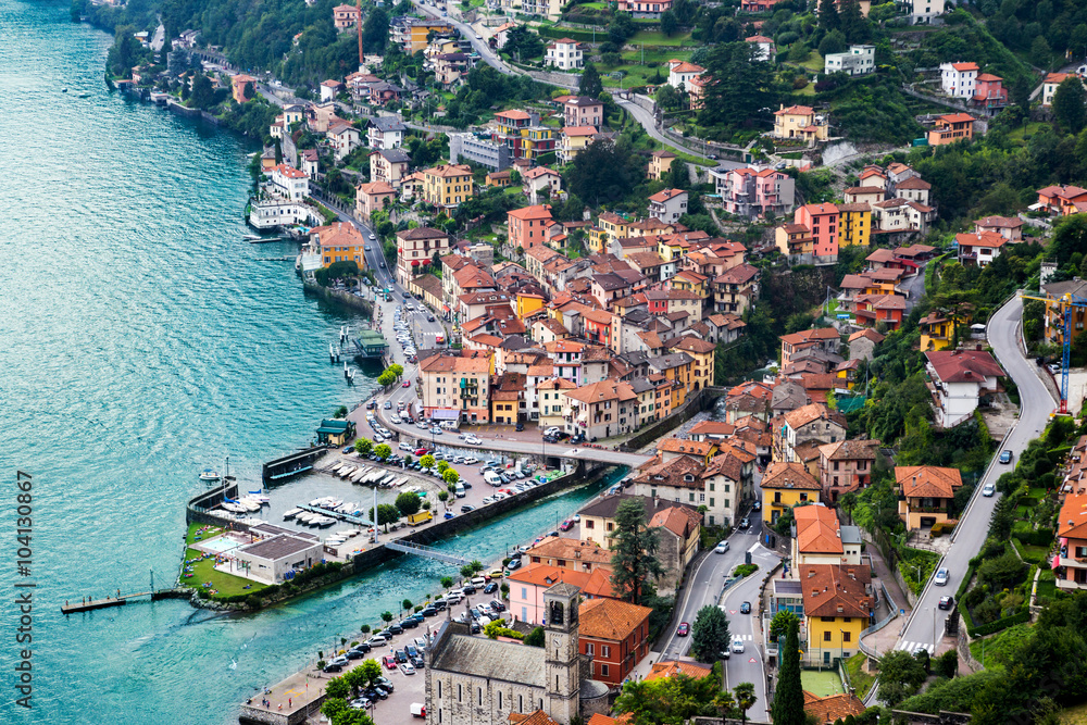 High resolution aerial view of the picturesque colorful Italian town Argegno by Lake Como. European vacation, living life style, architecture and travel concept.