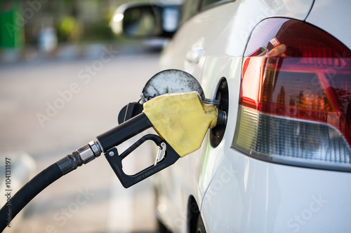 fuel nozzle in pouring to car