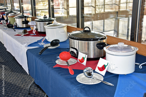 row of crock pots for a chili cook off in a restaurant