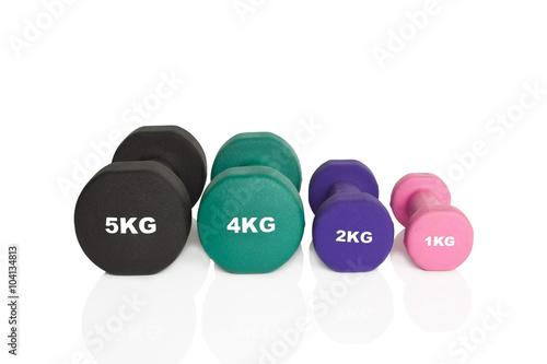 Fitness dumbbells. Black, green, purple and pink dumbbells isolated on white background. Weights for a fitness training.
