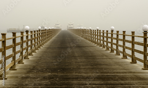Long wooden pier into the sea.