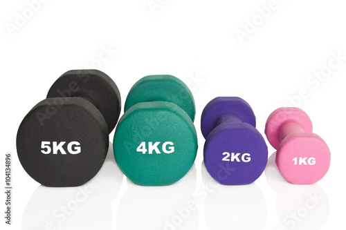 Fitness dumbbells. Black, green, purple and pink dumbbells isolated on white background. Weights for a fitness training.