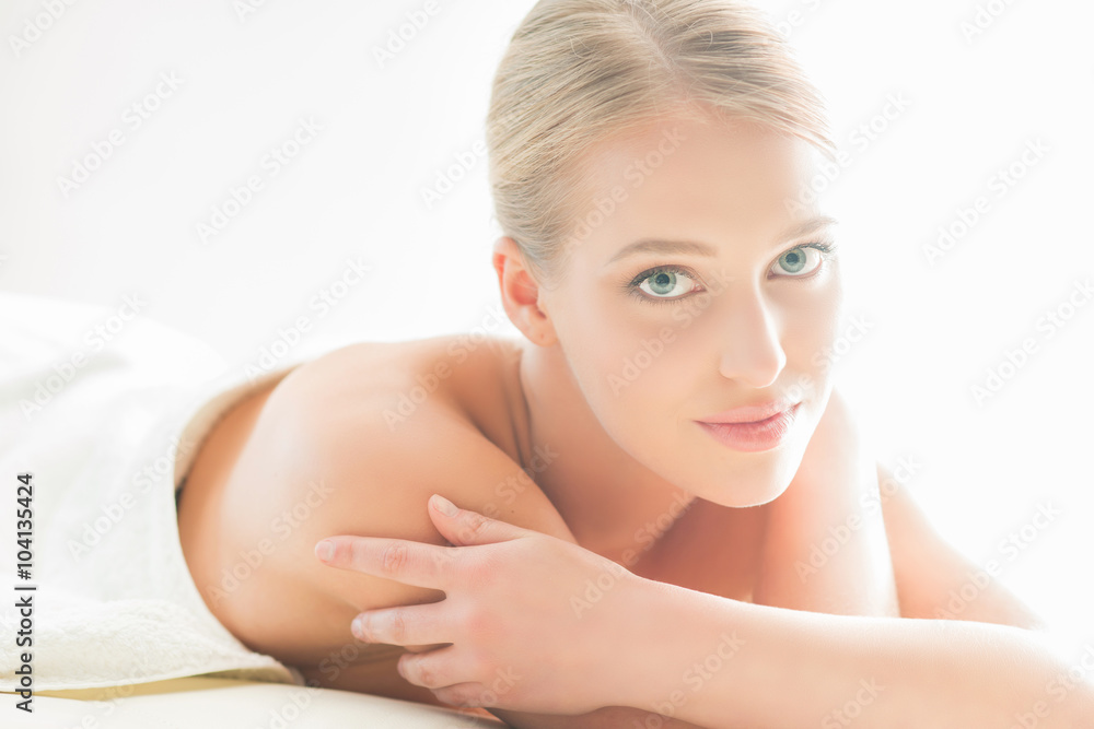 Beautiful woman laying on a mat in beauty salon. Beautiful woman laying on a mat in beauty salon.