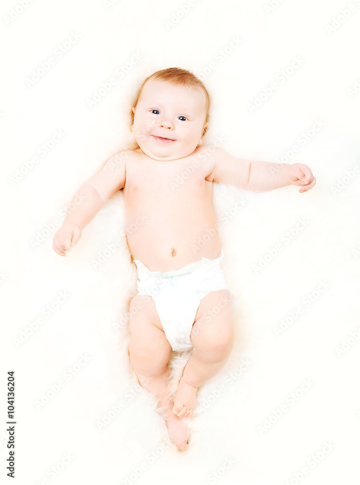 Portrait of a cute smiling infant baby in a diaper. Portrait of a cute smiling infant baby in a diaper.