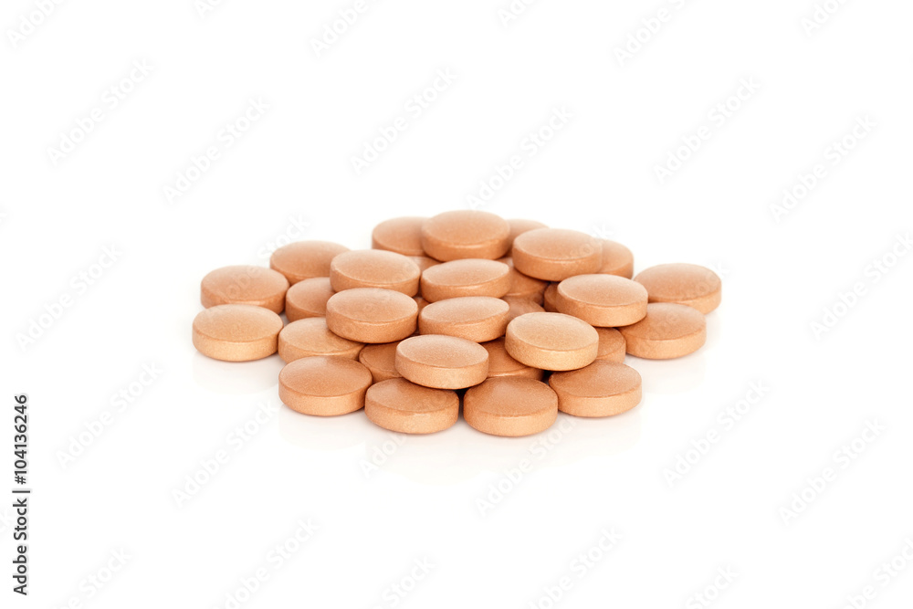 Iron Vitamin Tablet Supplements. A pile of iron vitamin supplement tablets isolated on a white background. Iron Vitamin Tablet Supplements. A pile of iron vitamin supplement tablets isolated on a white background.