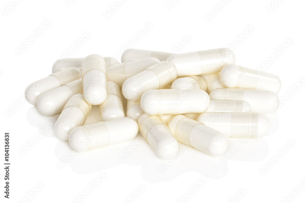 Magnesium Vitamin Supplements. A pile of magnesium supplement capsules isolated on a white background.