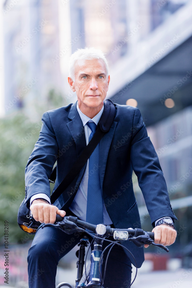 Fototapeta premium Successful businessman riding bicycle