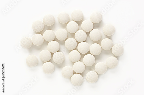Selenium Vitamin Supplements. A pile of selenium vitamin supplement tablets isolated on a white background from above.