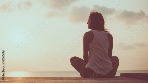 Young woman is doing yoga