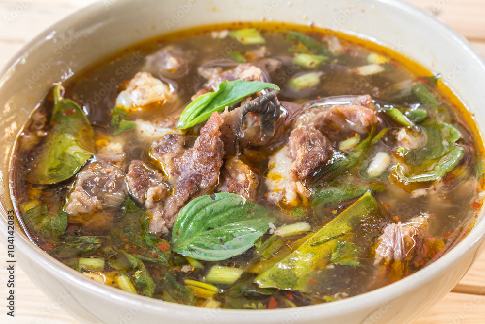 Beef Spicy Soup on wooden table - Thai cuisine and Food Beef Spicy Soup on wooden table - Thai cuisine and Food