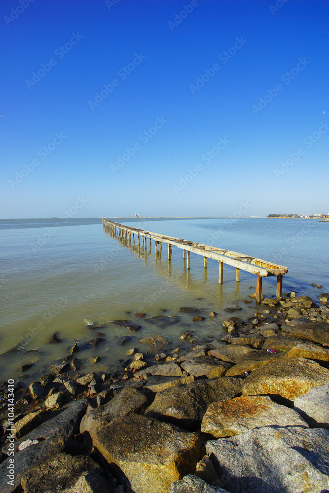 wooden pier in caribbean sea with beautiful blue sky and copy sp