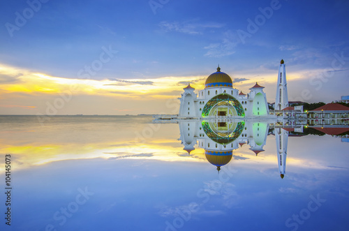 Majestic view of Darul Quran Mosque during sunset with mirror reflection