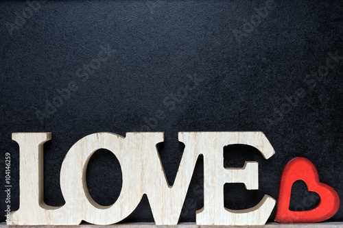 Love / Wooden blackboard with wooden letters and the word Love and little red heart