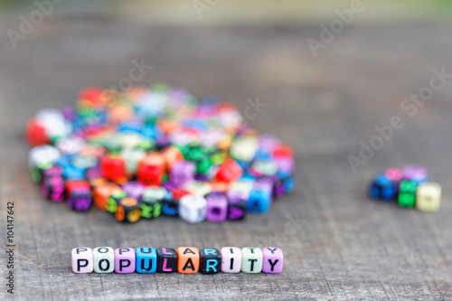 Popularity concept. Alphabet block with word popularity show two different group of block with majority behind the word popularity