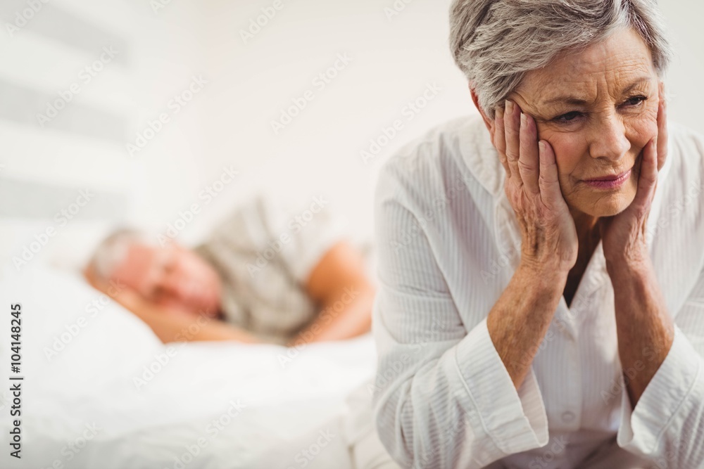 Worried senior woman sitting on bed Worried senior woman sitting on bed