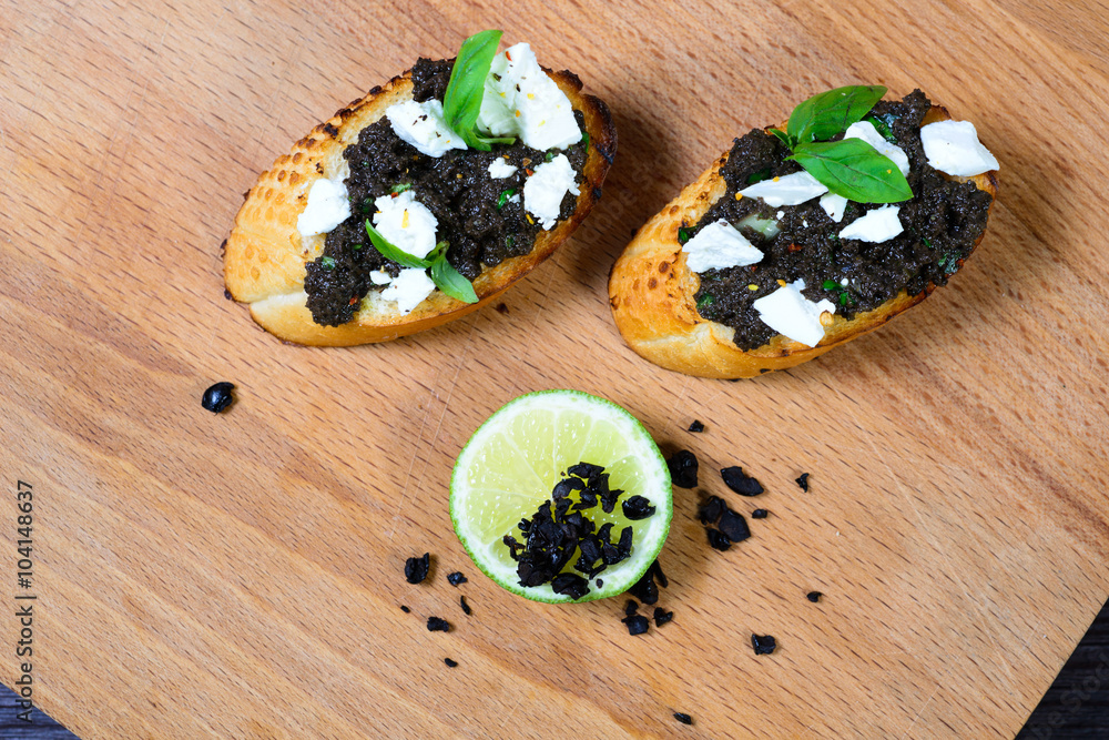 bruschetta Tapenade, with olives on old wooden Board bruschetta Tapenade, with olives on old wooden Board