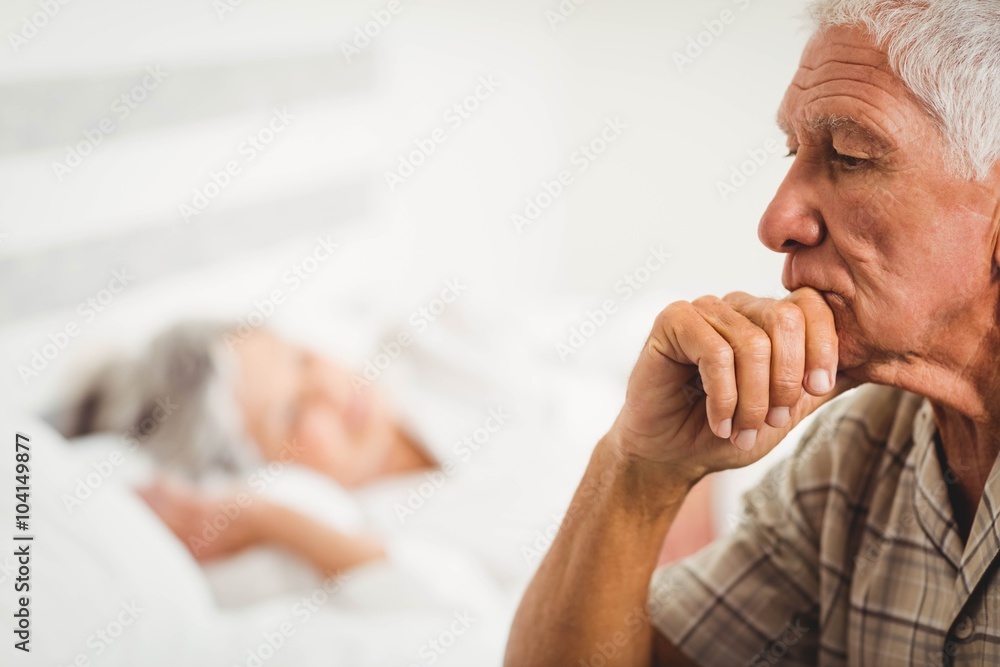 Worried senior man sitting on bed Worried senior man sitting on bed