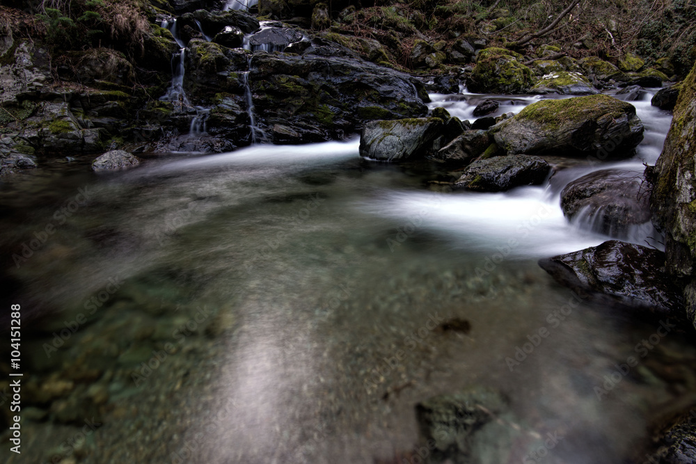 Fototapeta premium stream of mountain river among stones