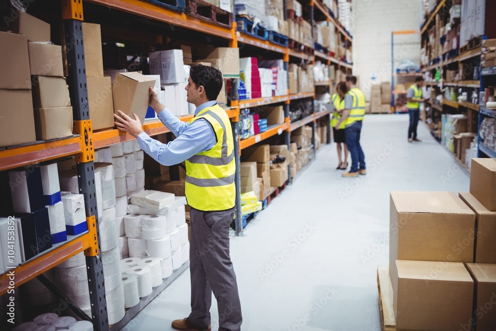 custom made wallpaper toronto digitalSmiling warehouse worker taking package in the shelf