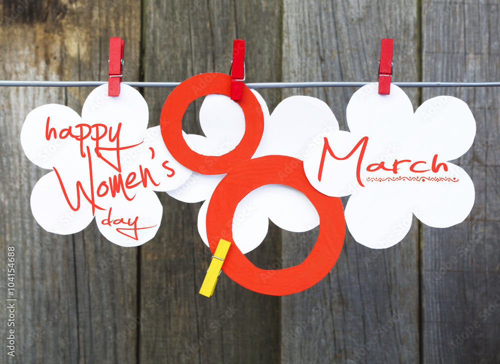 figure 8, paper flowers hang on clothespins in front wooden background ...