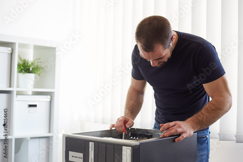 Man repairing computer in the office