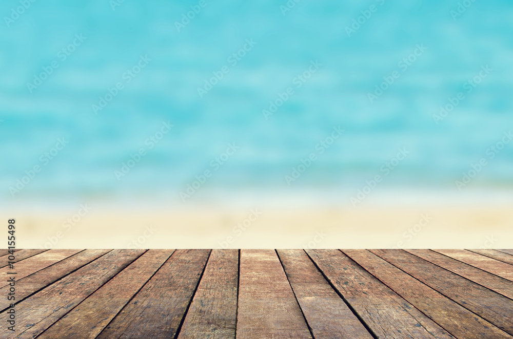 Wood table on blur sea water and summer background