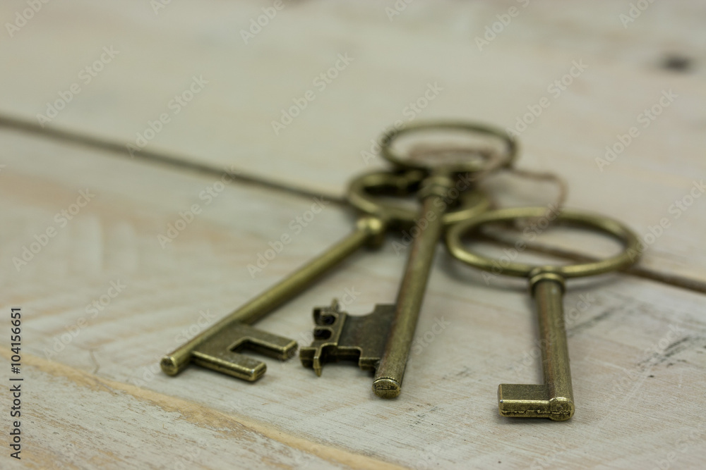 Old keys on a rustic background Old keys on a rustic background