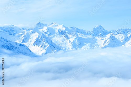 beautiful winter landscape of Caucasus mountains with clouds and © Alisa