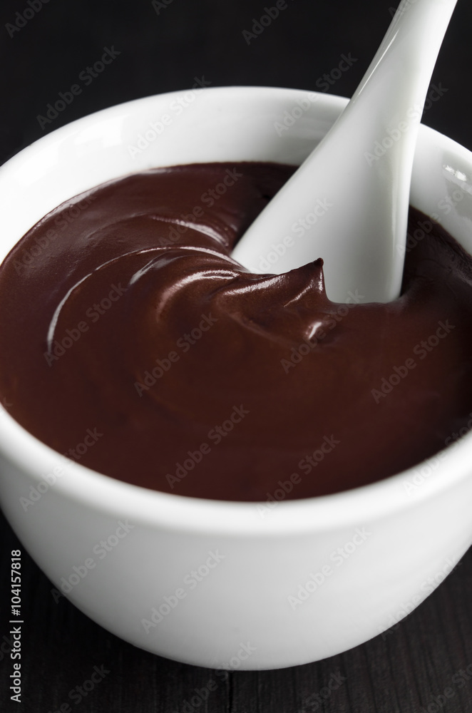 Cocoa (dark chocolate) face and body mask in a bowl close up Cocoa (dark chocolate) face and body mask in a bowl close up