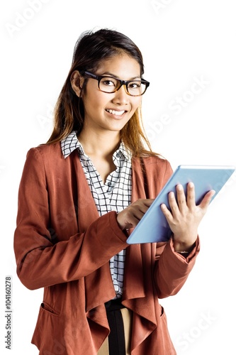 Smiling businesswoman with eyeglasses using a tablet