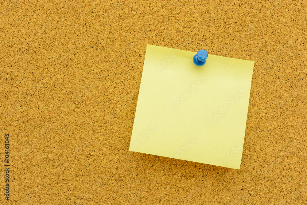 Note paper with blue pin on the cork board Note paper with blue pin on the cork board