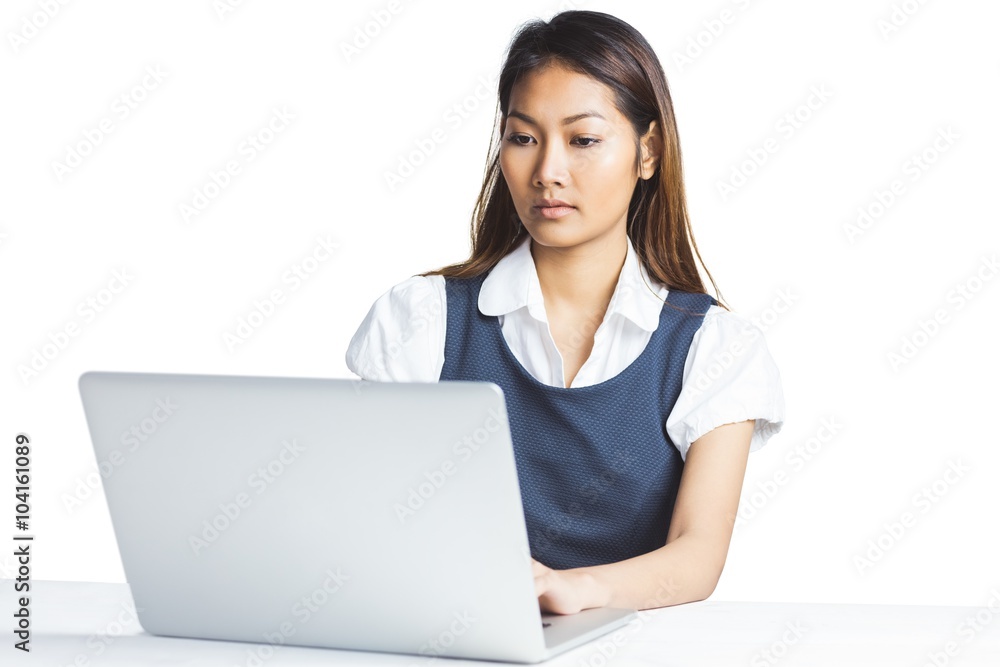 Concentrated businesswoman using a laptop Concentrated businesswoman using a laptop